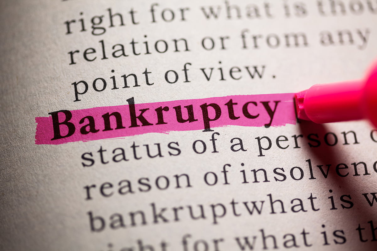 definition of bankruptcy in a dictionary being highlighted in pink